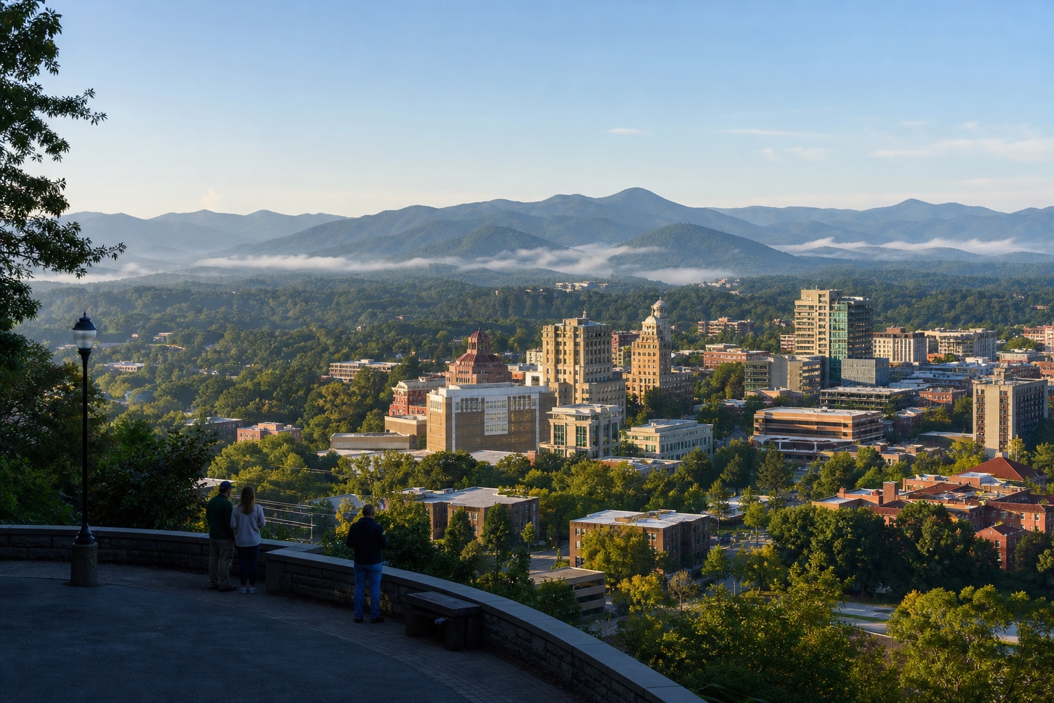 Downtown Asheville's leafy streets and historic skyline below layered Blue Ridge Mountains