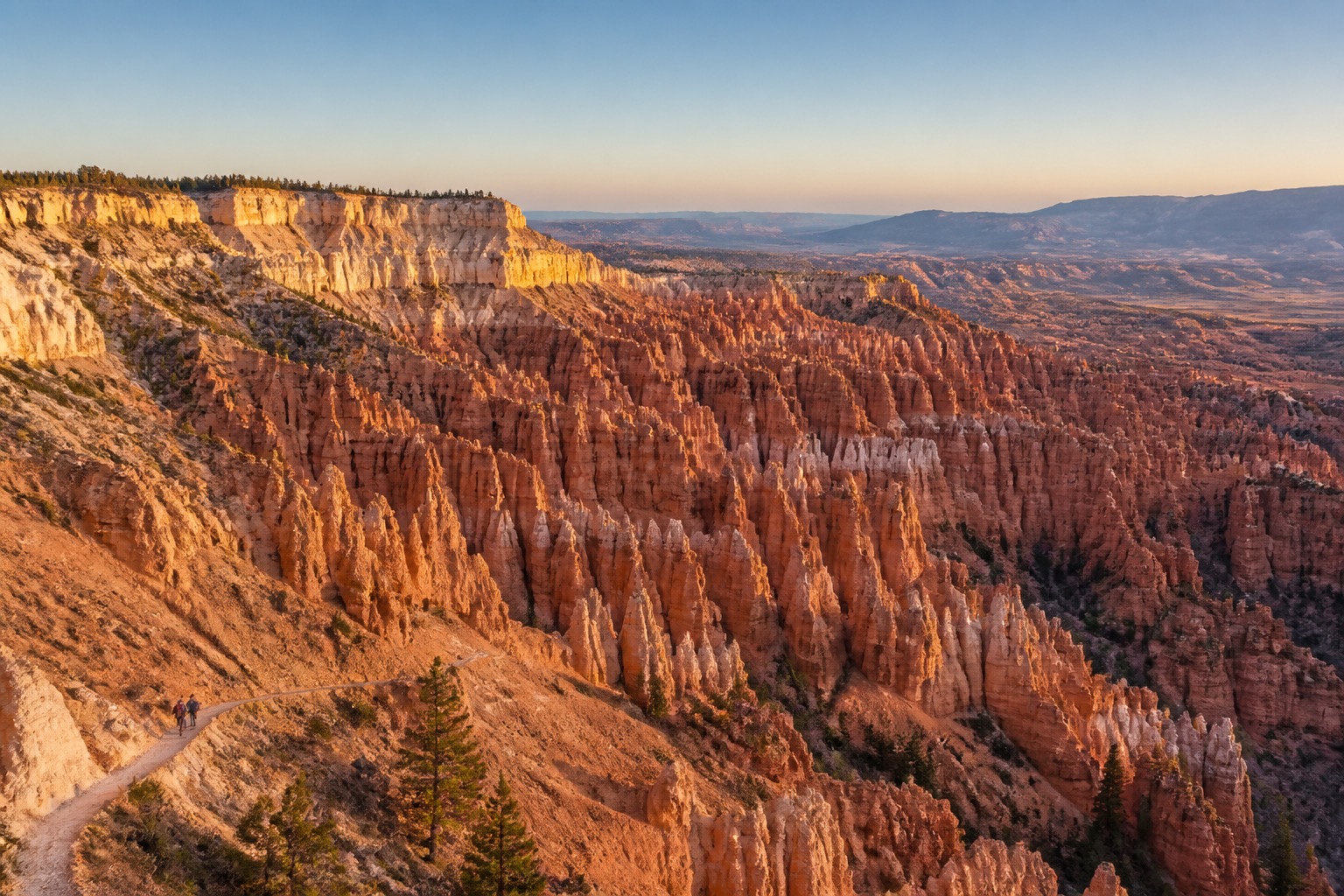 Bryce Amphitheater hoodoos in crisp natural morning light with hikers small in the landscape