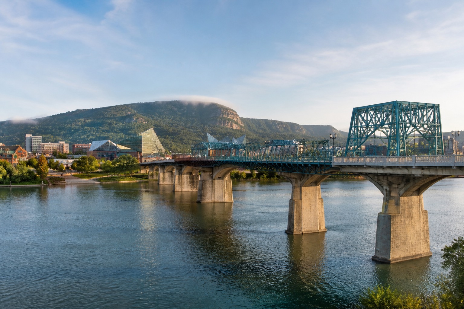 Chattanooga riverfront, pedestrian bridge and Lookout Mountain under clear morning light