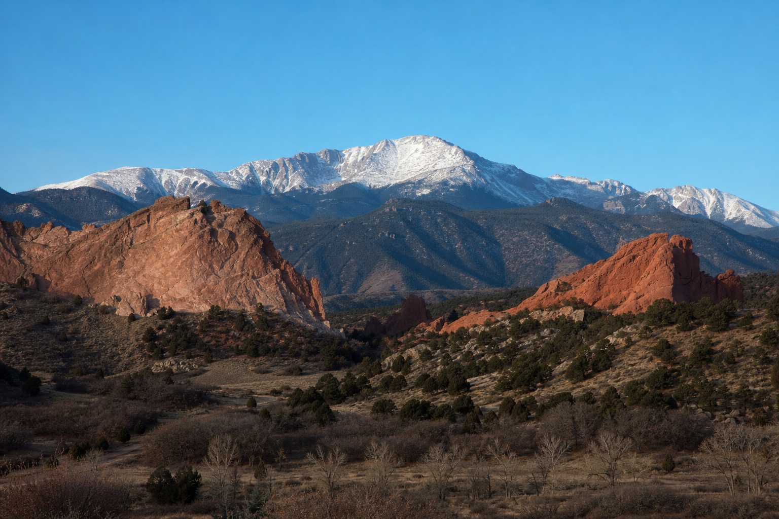 Garden of the Gods red rock formations with Pikes Peak in clear morning light