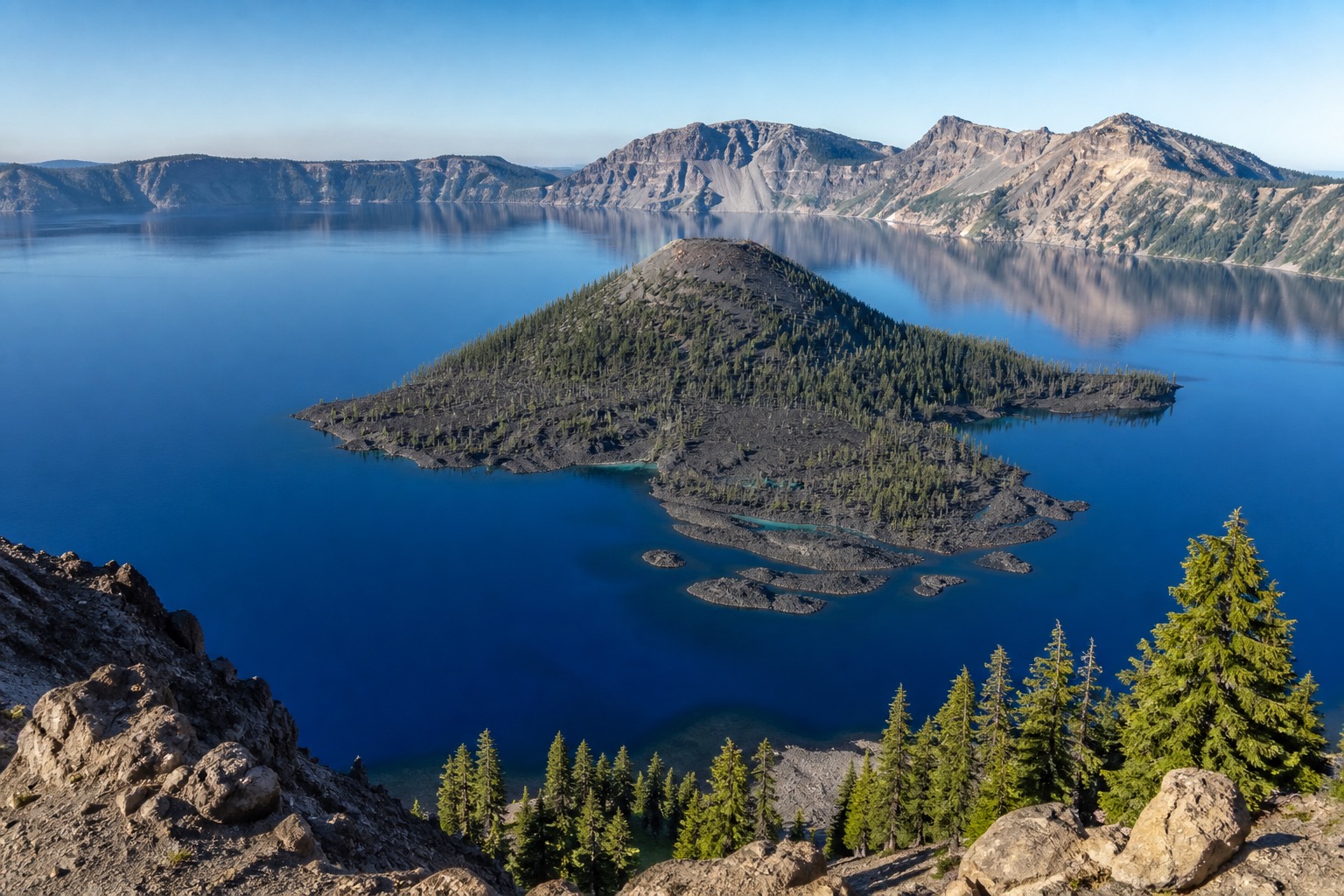 Crater Lake's deep blue caldera and Wizard Island in crisp natural morning light