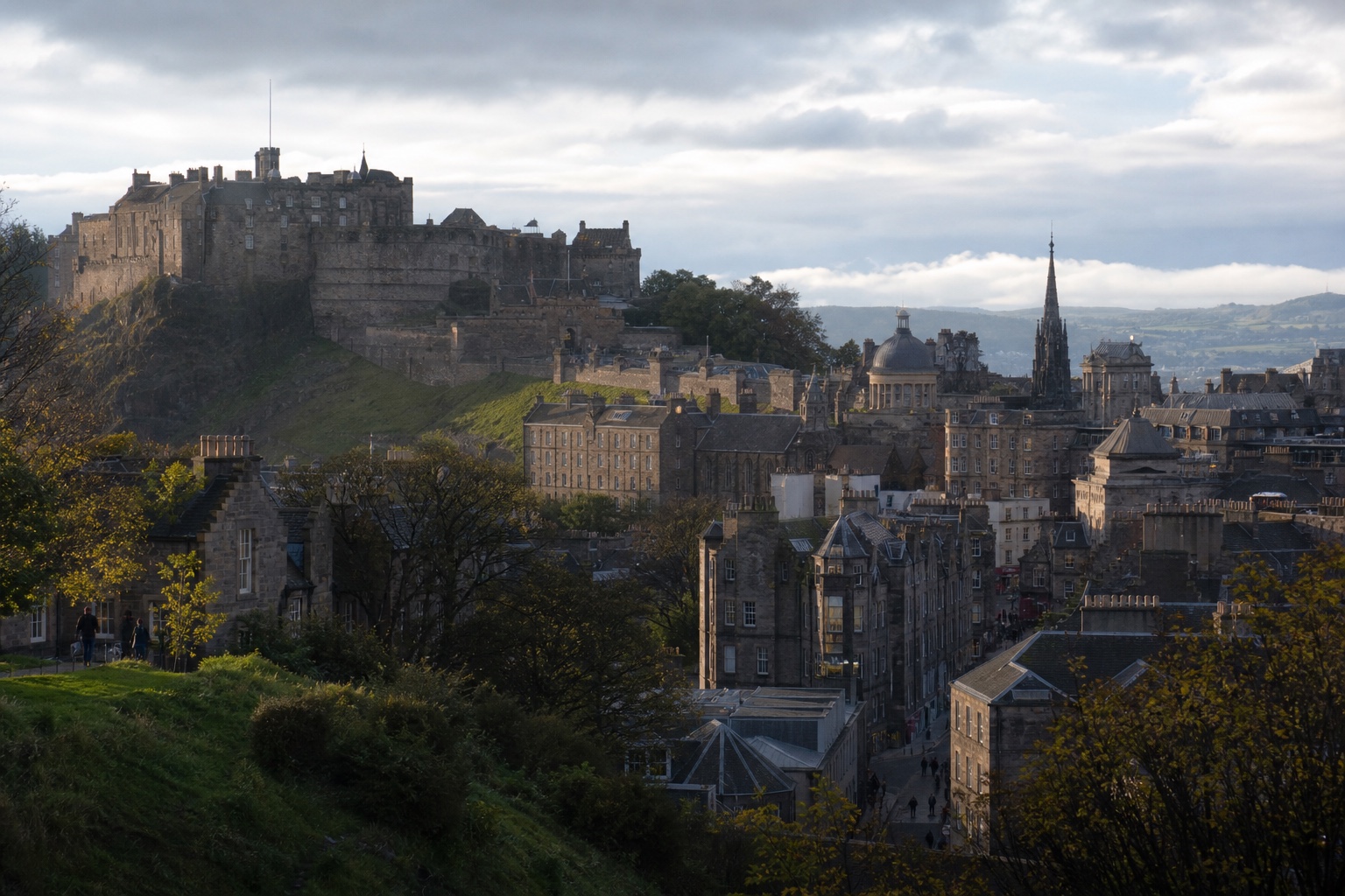 Edinburgh Castle and the layered stone city beneath a clearing morning sky
