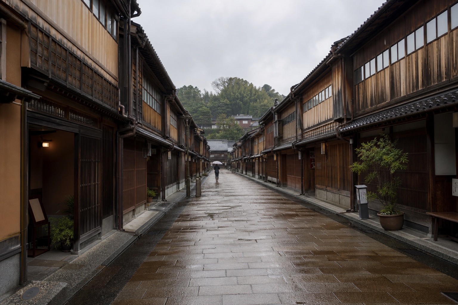 A rain-washed street lined with dark timber teahouses in Kanazawa's Higashi Chaya district