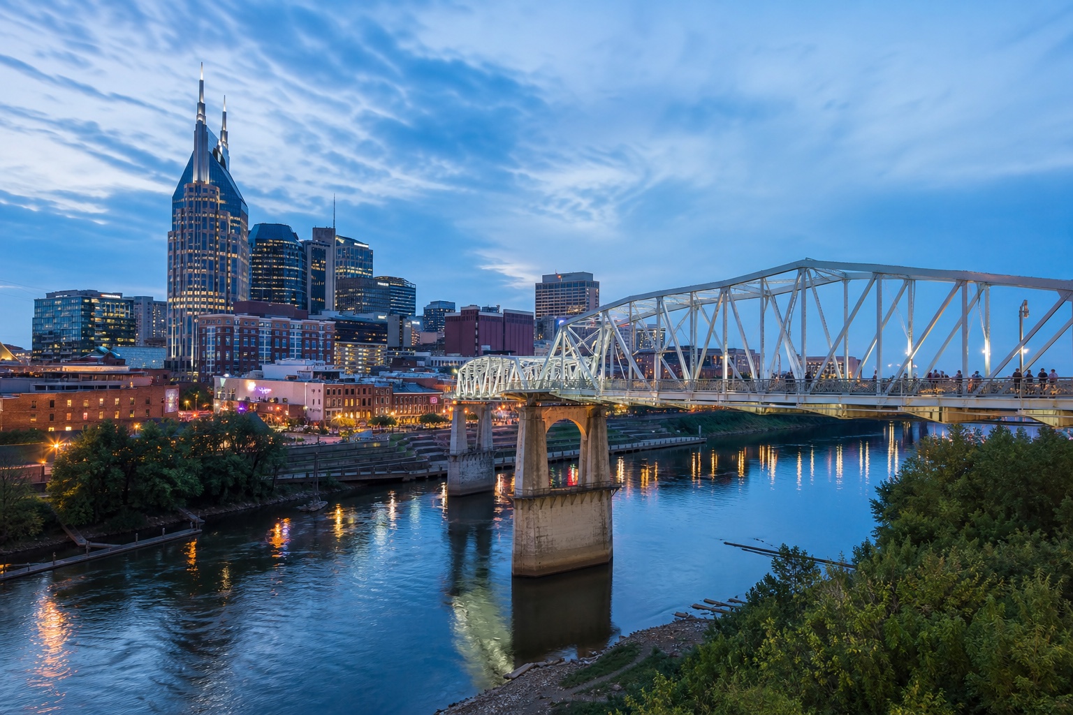 Downtown Nashville and the John Seigenthaler Pedestrian Bridge across the Cumberland River at blue hour