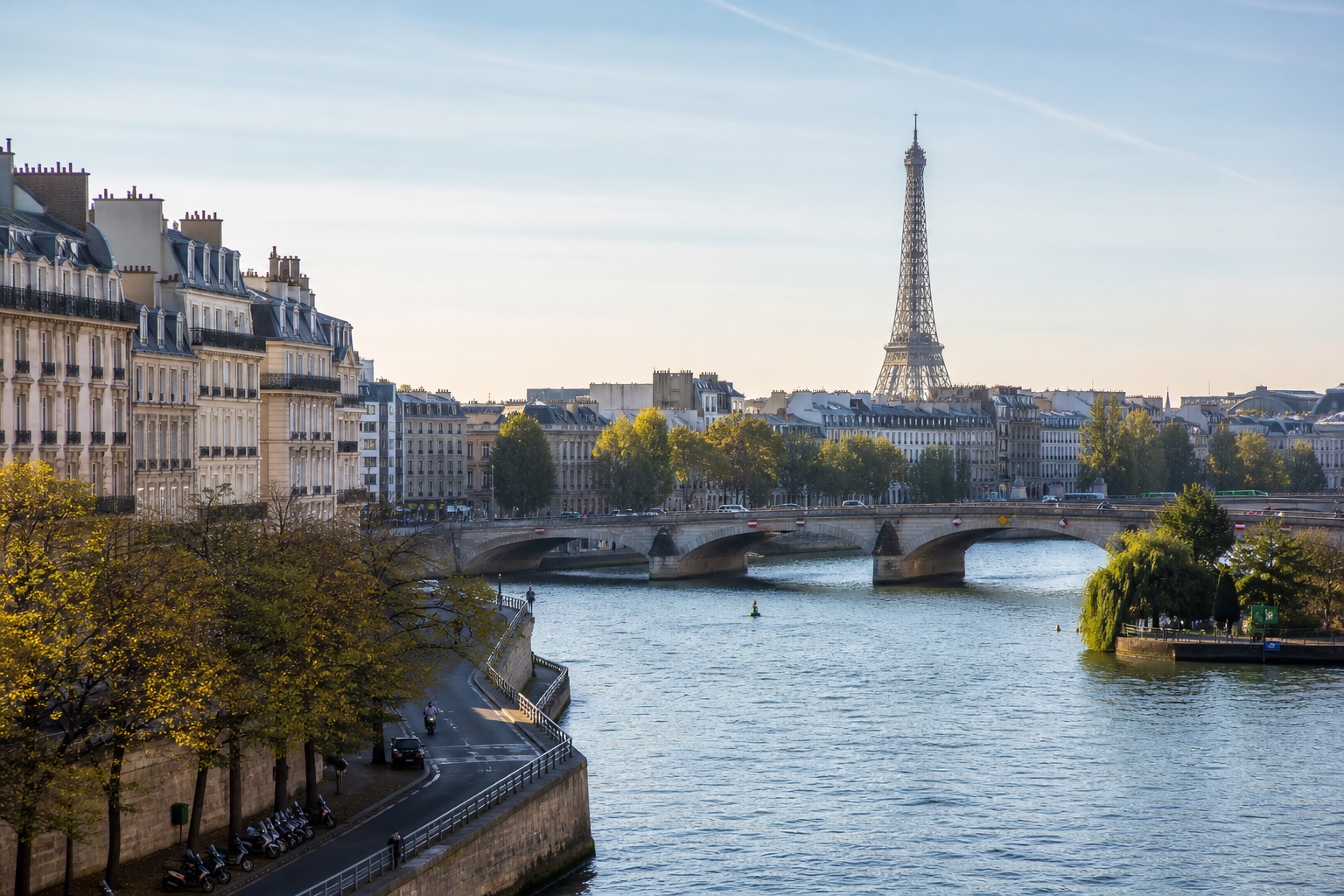 The Seine, Paris rooftops, and Eiffel Tower in clear morning light