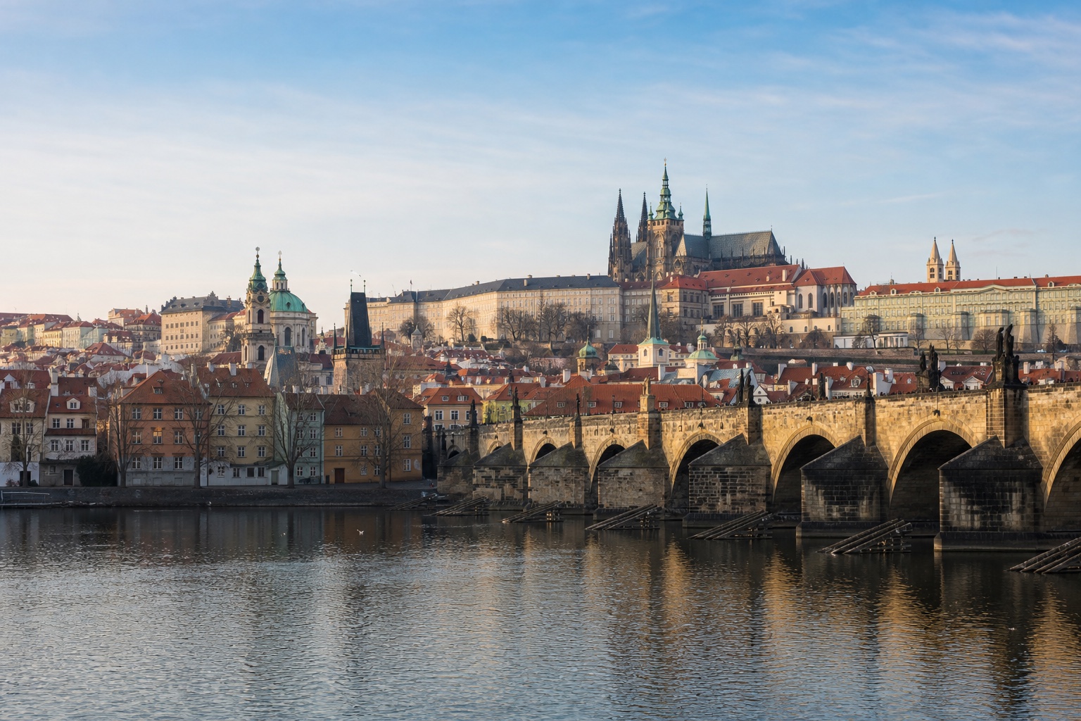 Charles Bridge, Prague Castle, and the historic city beside the Vltava in morning light