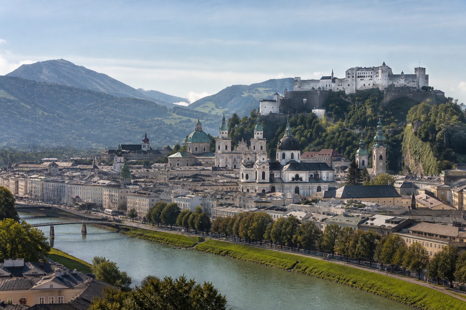 Salzburg's baroque old town beside the Salzach, Hohensalzburg Fortress, and alpine foothills