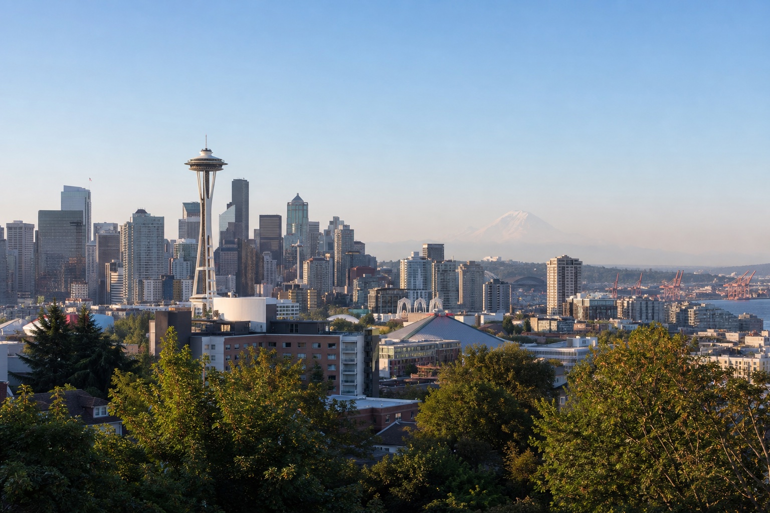Seattle skyline with the Space Needle, Elliott Bay and Mount Rainier faintly visible beyond the city