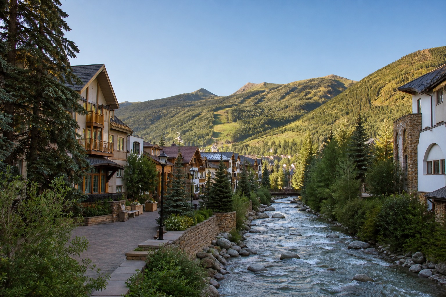 Vail's pedestrian alpine village beside Gore Creek with mountain ridges beyond