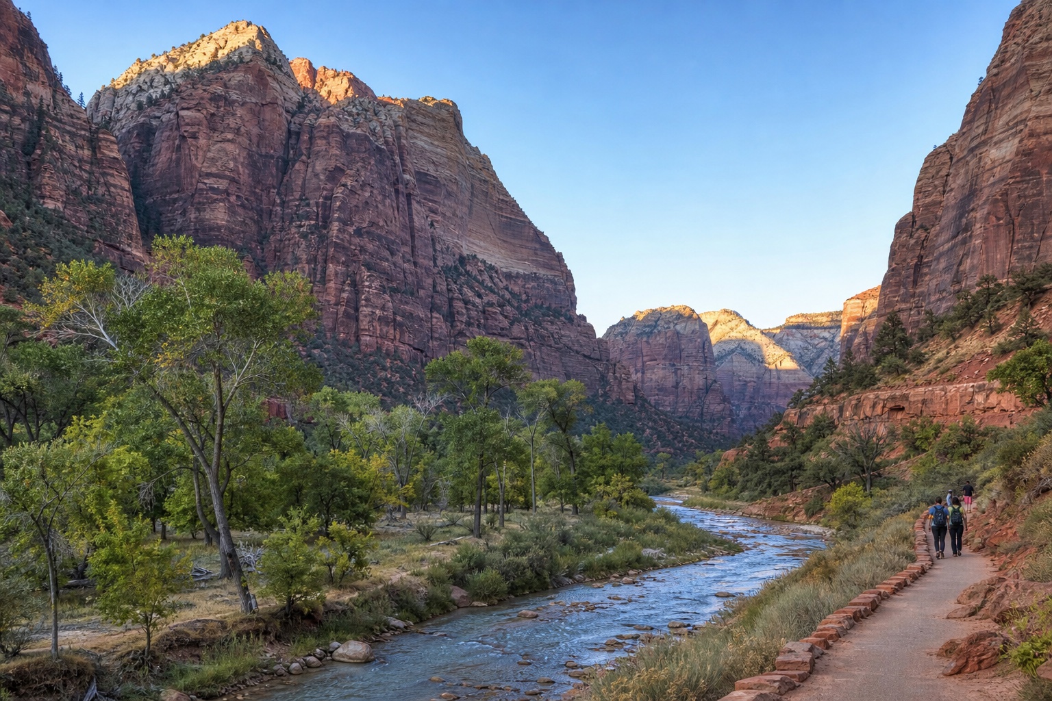 Zion Canyon sandstone walls, cottonwoods and the Virgin River beside a maintained valley trail